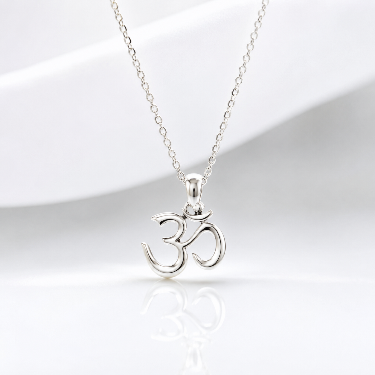 Silver Om symbol necklace on a white background
